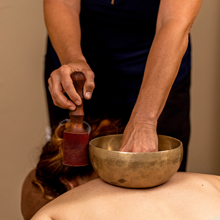 A woman laying down on a massage table while receiving a massage treatment at Natural Balance Massage Therapy & Wellness Center in Palm Harbor, Florida.
